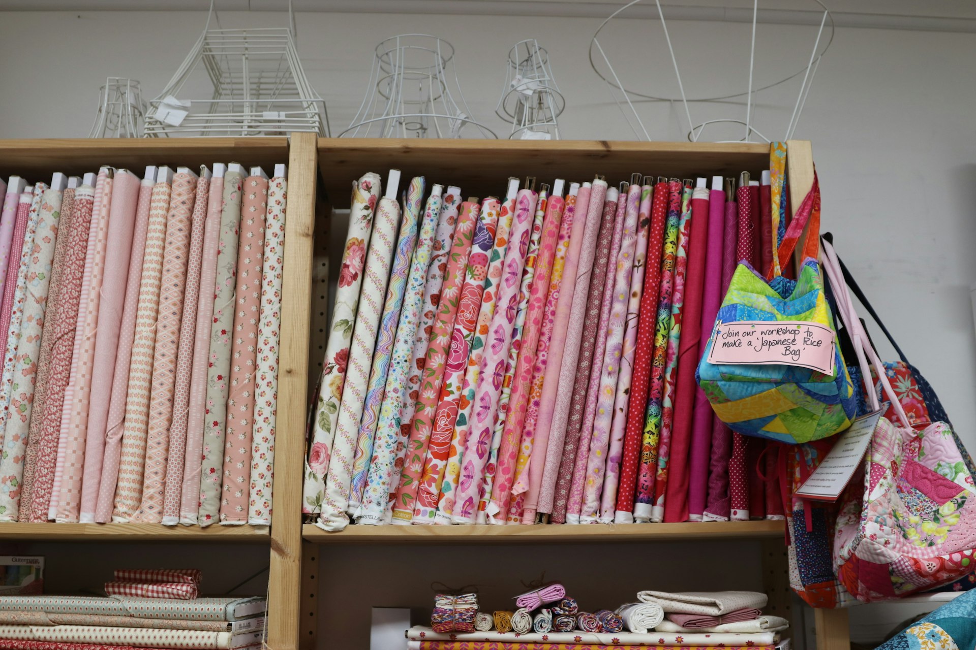 Shelves are filled with colorful fabric bolts.